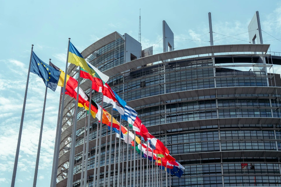 a large building with a lot of flags in front of it